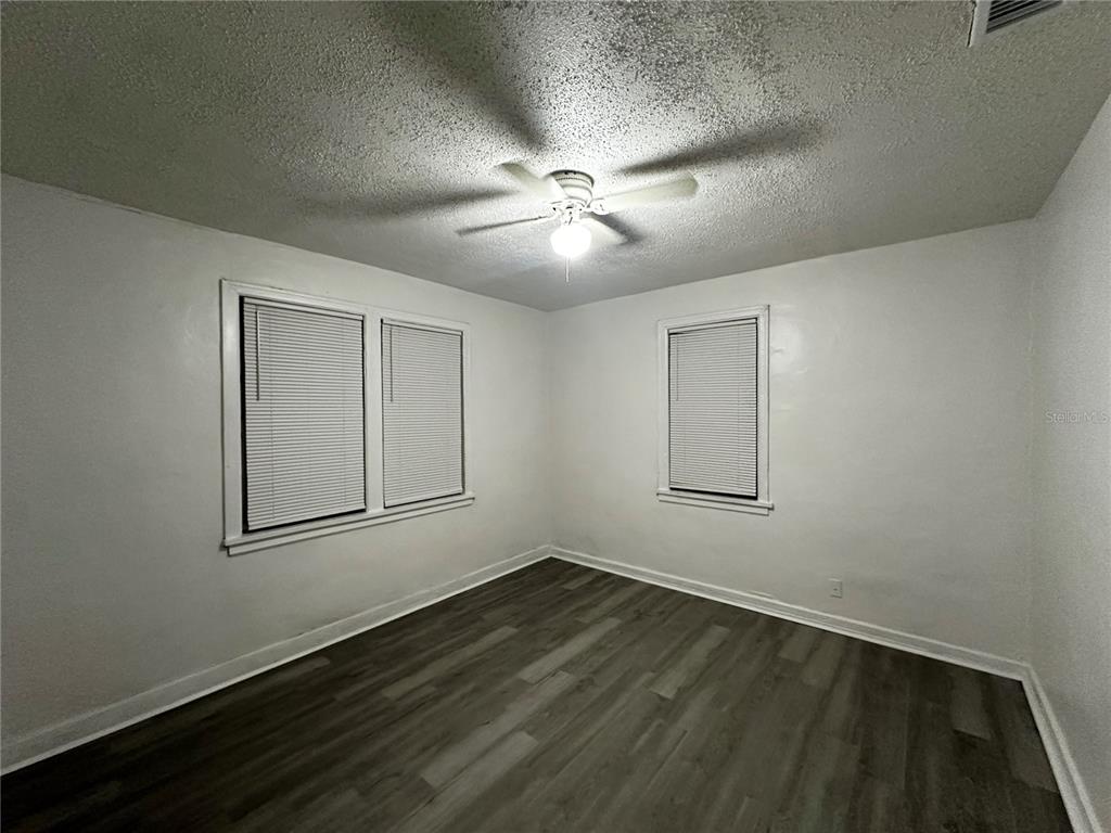 1907 Rio Grande Avenue Orlando, FL 32805 - Photo 16 of 17 a view of an empty room with wooden floor and a window