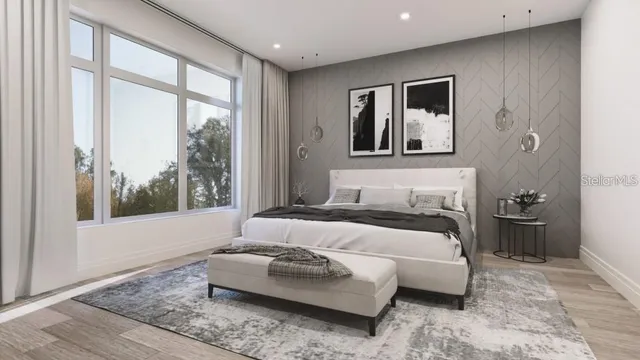 a bedroom with a large bed couch and a large window