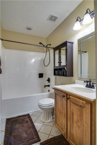 764 Hunters Crossing Lane Springfield, TN 37172 - Photo 12 of 17 Hall bath has the rub bronzed faucets, tiled floors and there is a linen closet for extra storage