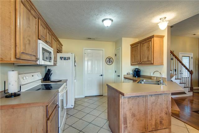 The kitchen has beautiful cabinetry and nice counter space.  Walk in directly form the garage to unload your groceries.  There is also a pantry for added storage.