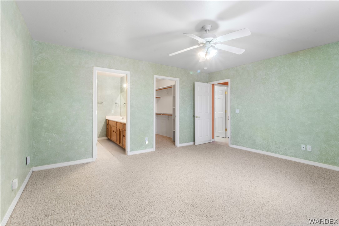2158 Ranch Road Kingman, AZ 86401 - Photo 26 of 48 an empty room with closet and a ceiling fan