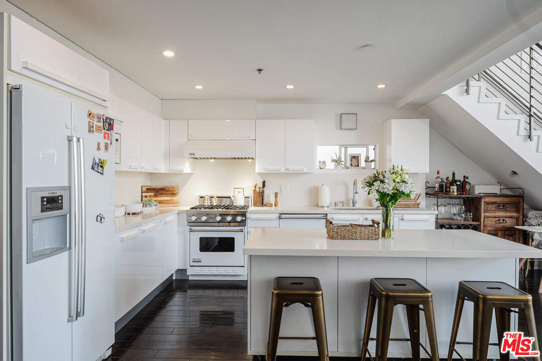 13326 Beach Avenue, Unit 202 Marina del Rey, CA 90292 - Photo 3 of 17 a kitchen with appliances a counter space and a dining table