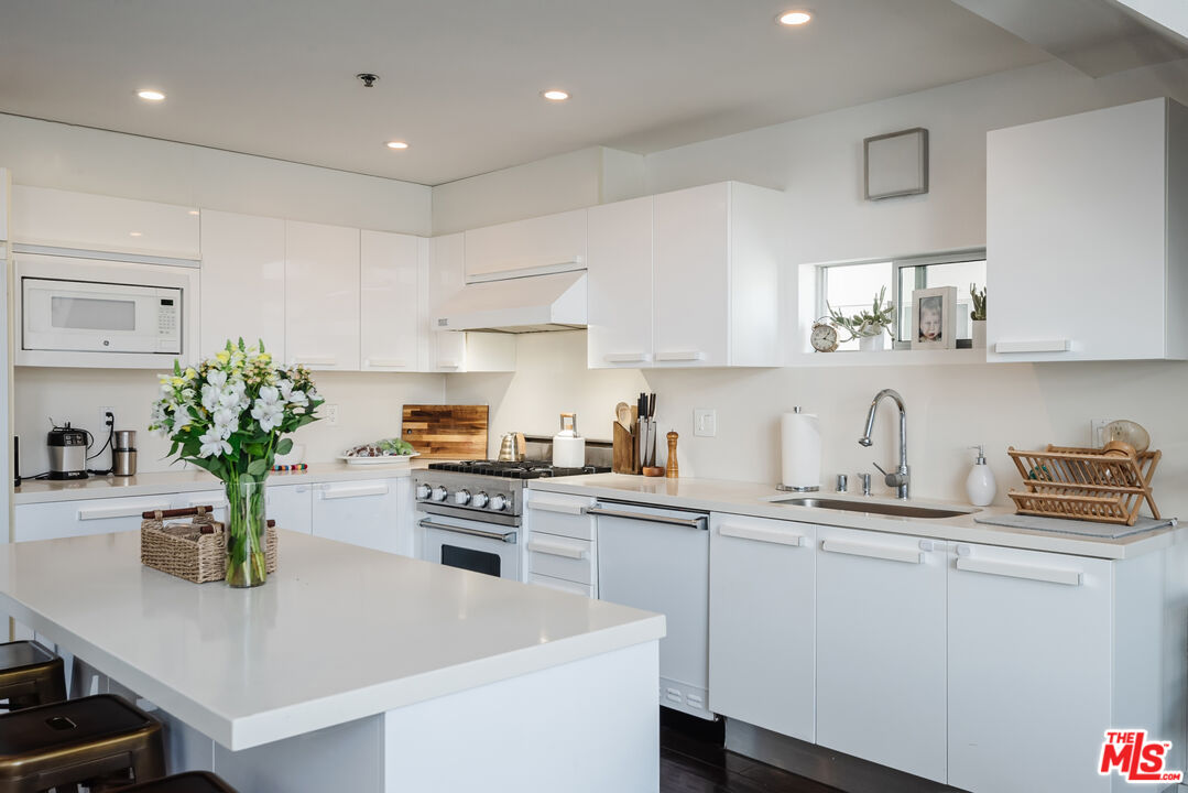 13326 Beach Avenue, Unit 202 Marina del Rey, CA 90292 - Photo 4 of 17 a kitchen with a sink a stove and cabinets