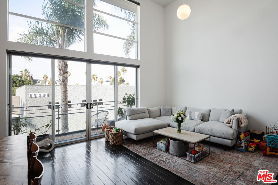 13326 Beach Avenue, Unit 202 Marina del Rey, CA 90292 - Photo 8 of 17 a living room with furniture and a large window