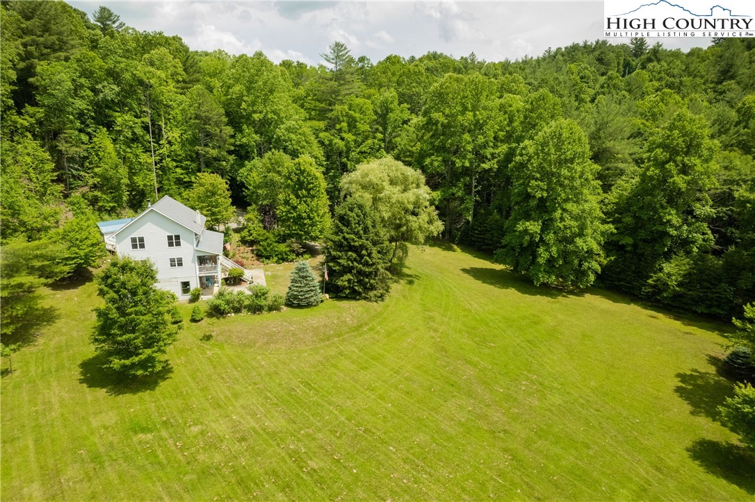 624 Wildcat Ridge Road Deep Gap, NC 28618 - Photo 2 of 50 a view of a large garden with plants and large trees