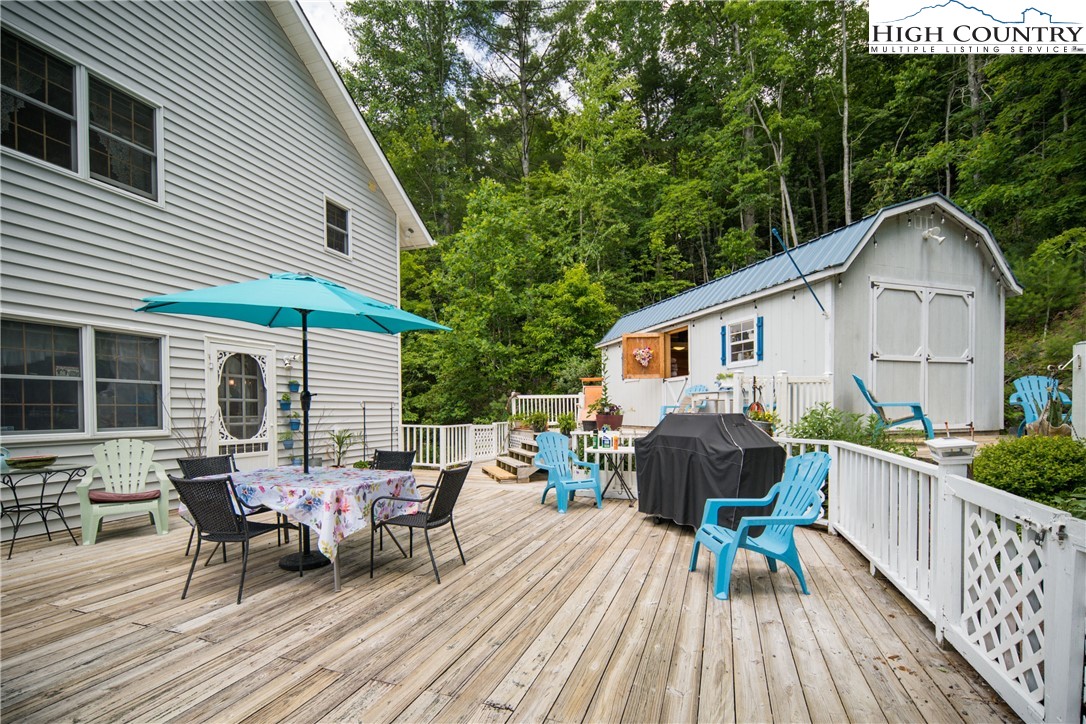 624 Wildcat Ridge Road Deep Gap, NC 28618 - Photo 45 of 50 a view of a house with wooden deck and furniture