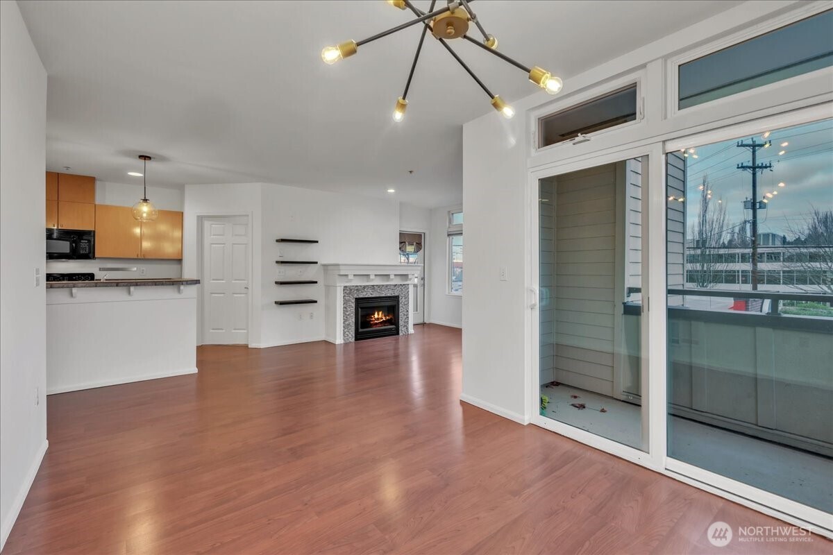 18 Dravus Street, Unit 207 Seattle, WA 98109 - Photo 13 of 34 a view of a kitchen with a sink and a refrigerator wooden floor