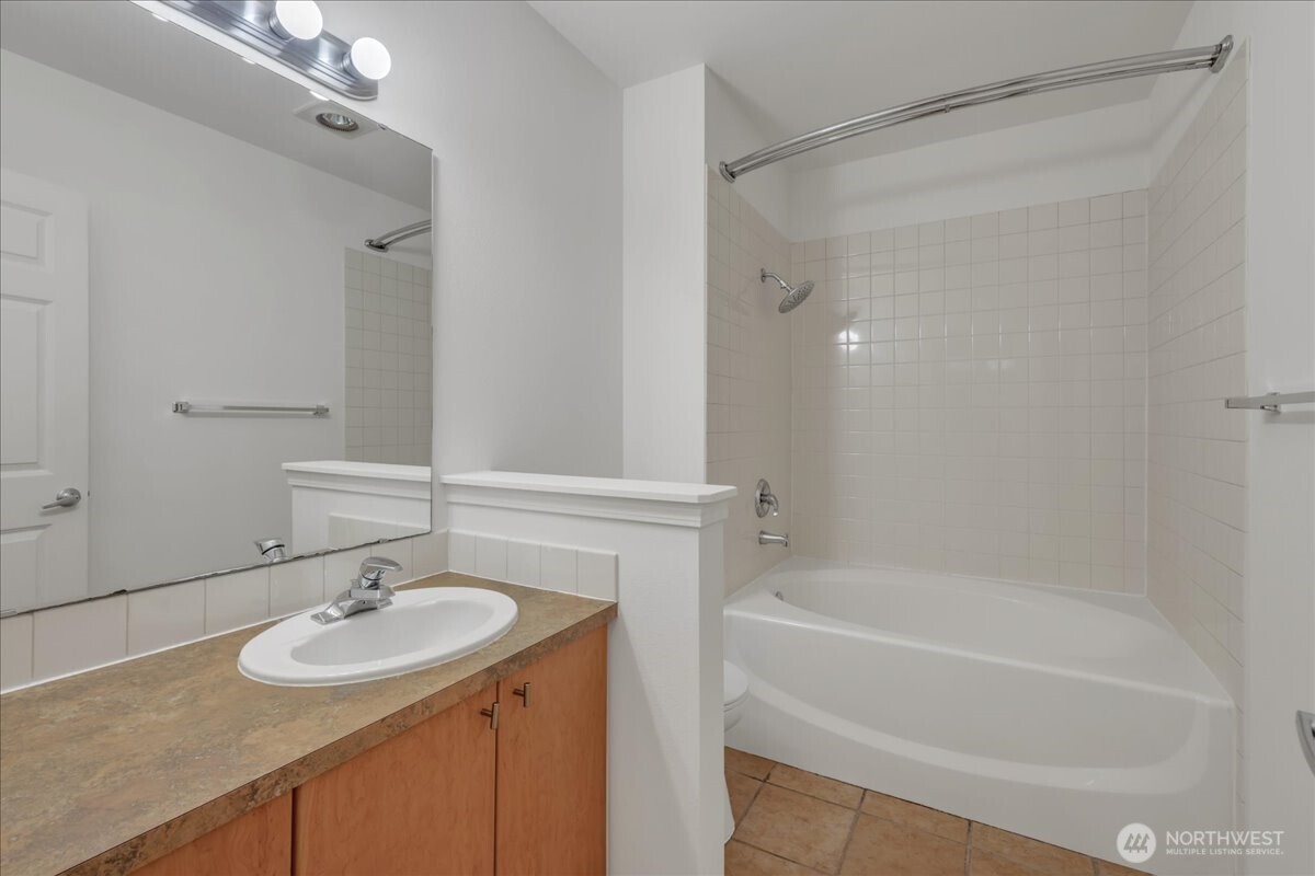 18 Dravus Street, Unit 207 Seattle, WA 98109 - Photo 20 of 34 a bathroom with a sink and a mirror