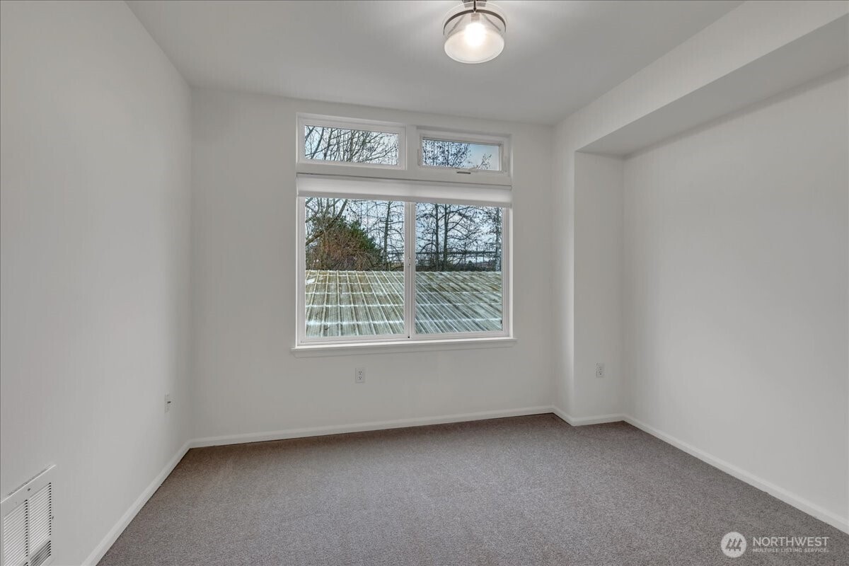 18 Dravus Street, Unit 207 Seattle, WA 98109 - Photo 22 of 34 a view of an empty room with a window