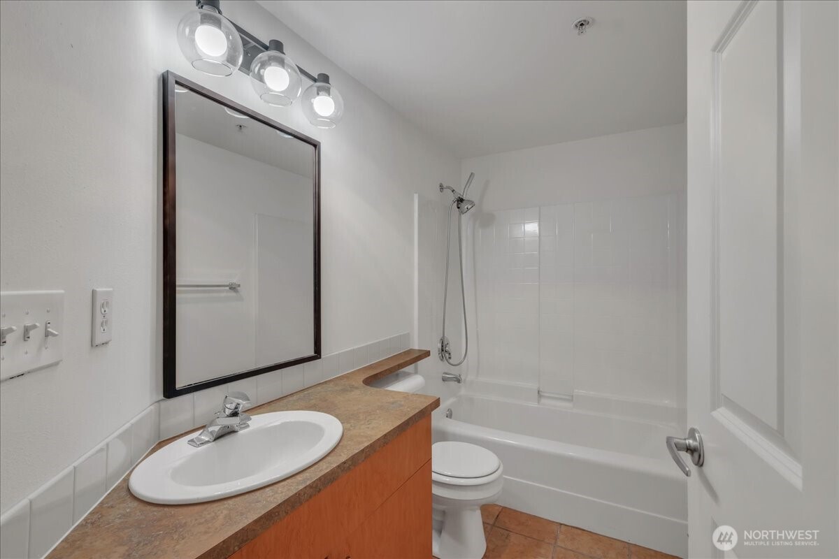 18 Dravus Street, Unit 207 Seattle, WA 98109 - Photo 24 of 34 a bathroom with a sink a toilet and shower
