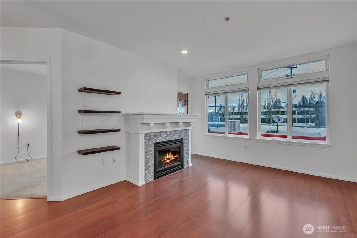 18 Dravus Street, Unit 207 Seattle, WA 98109 - Photo 10 of 34 an empty room with windows and fireplace
