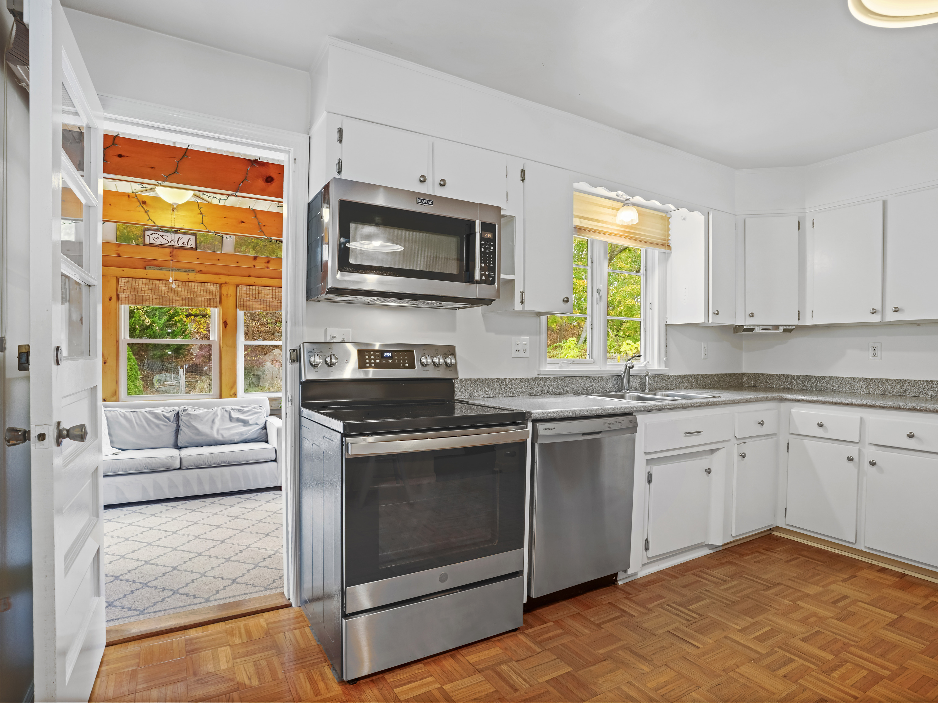 5 Maher Drive Norwalk, CT 06850 - Photo 11 of 36 a kitchen with stainless steel appliances granite countertop a stove a sink and a microwave