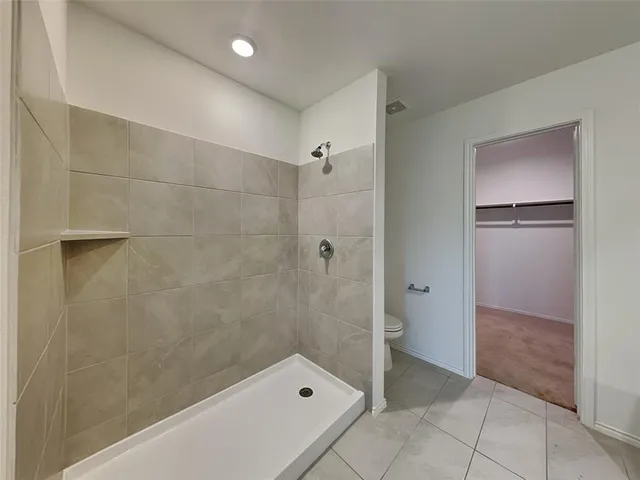 a bathroom with a glass shower door