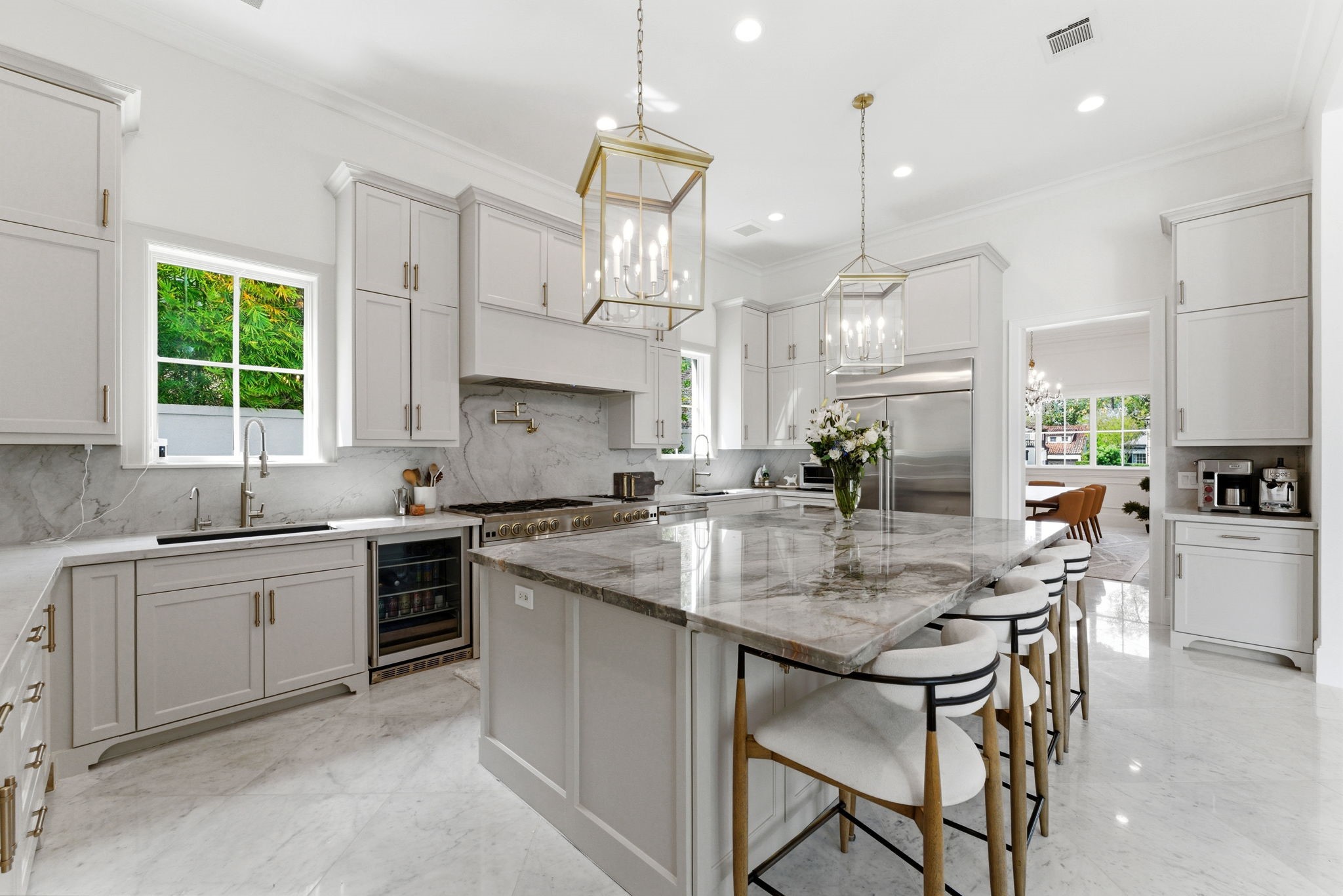 2211 Troon Road Houston, TX 77019 - Photo 12 of 44 a kitchen with stainless steel appliances granite countertop a table chairs sink and stove top oven