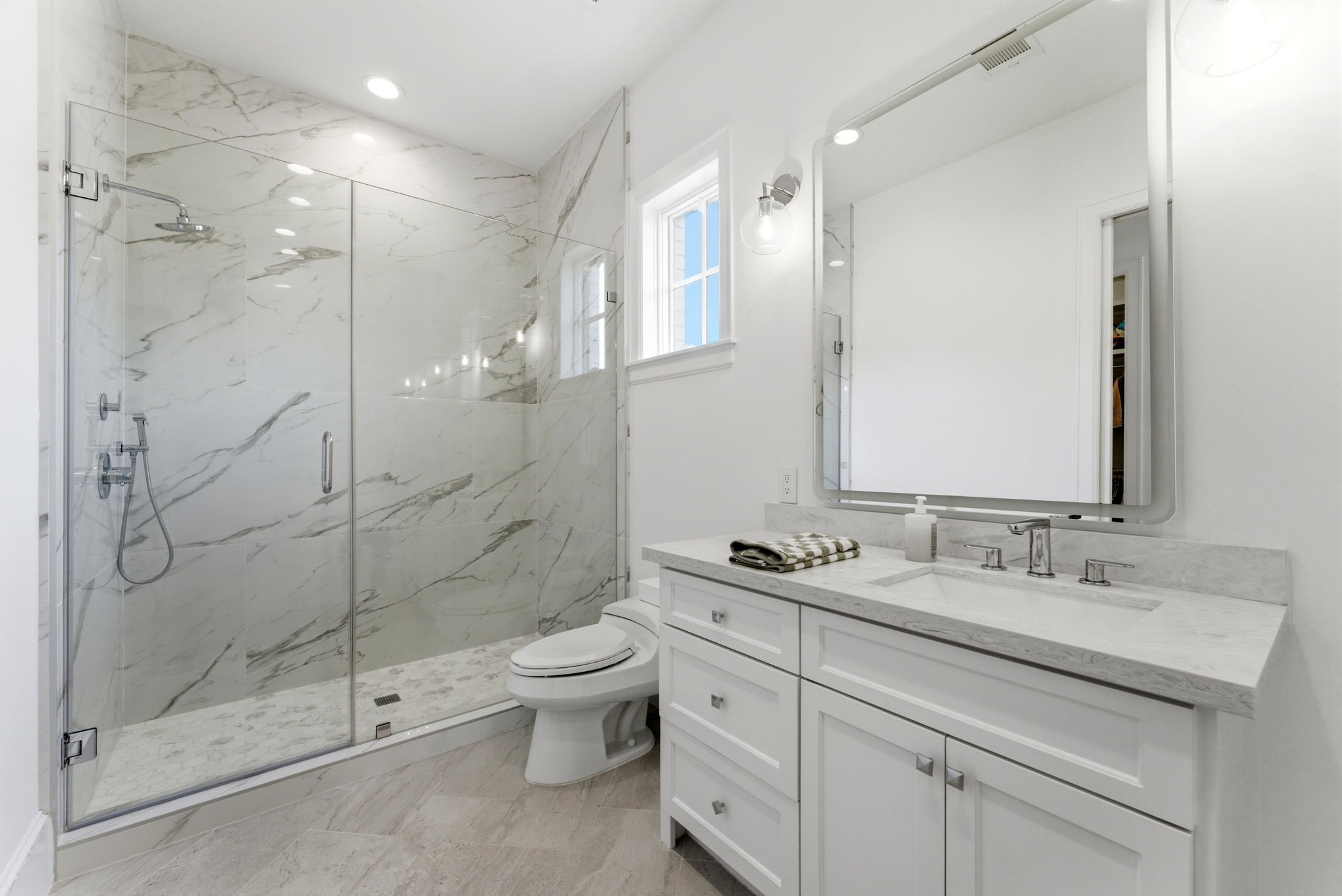 2211 Troon Road Houston, TX 77019 - Photo 25 of 44 a bathroom with a shower sink vanity and mirror