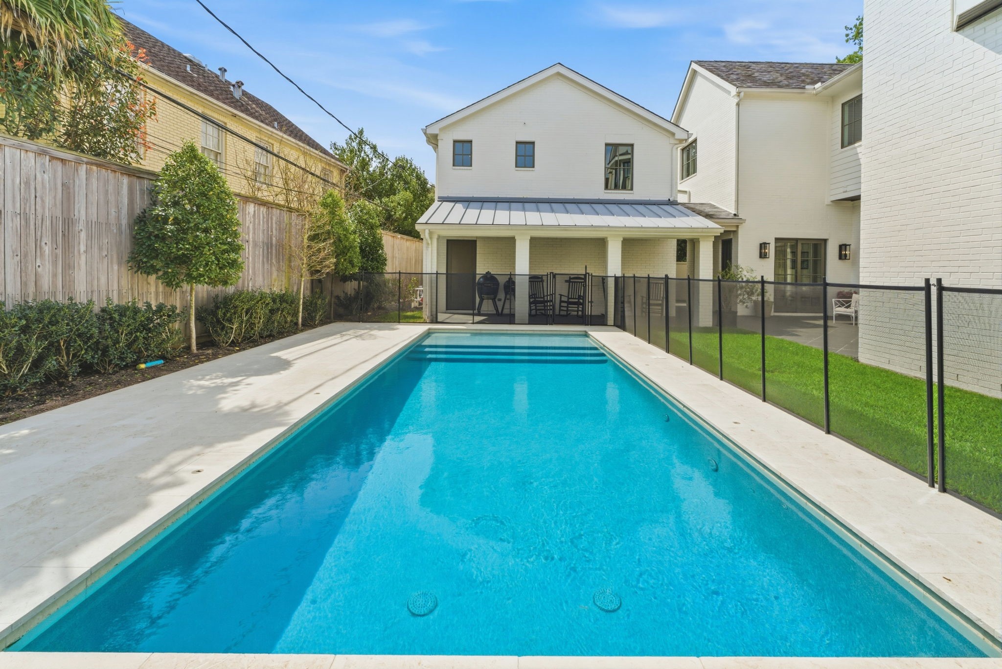 2211 Troon Road Houston, TX 77019 - Photo 44 of 44 a view of a white house with a swimming pool