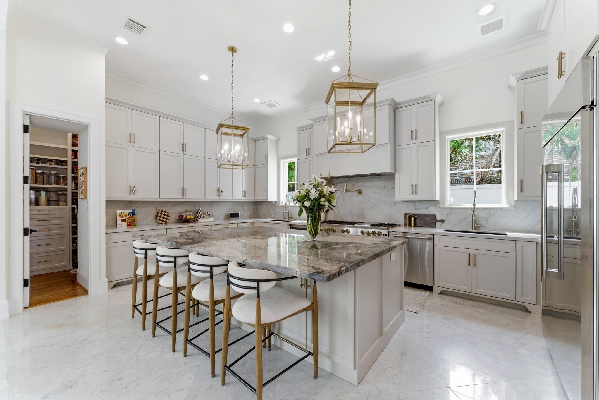 2211 Troon Road Houston, TX 77019 - Photo 10 of 44 a kitchen with stainless steel appliances granite countertop a stove top oven a sink a refrigerator and white cabinets