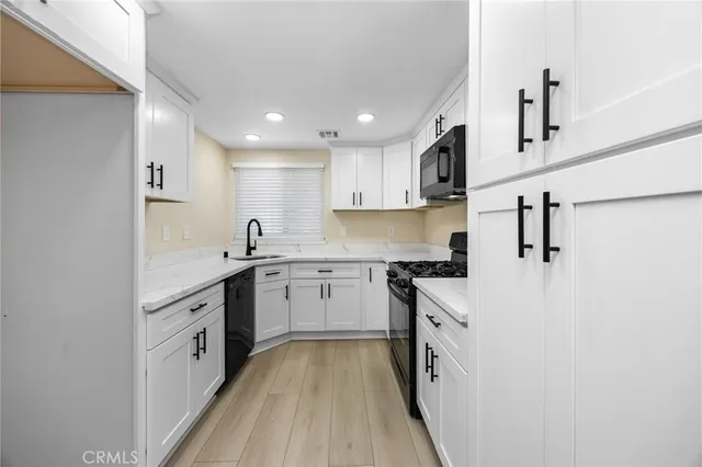 a bathroom with a sink and cabinets