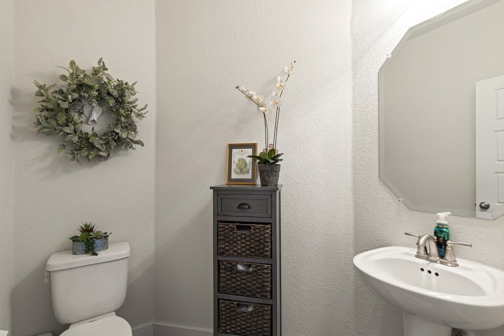 7409 Merrick Lane, Unit 40 Austin, TX 78745 - Photo 13 of 37 a bathroom with a toilet a sink and mirror