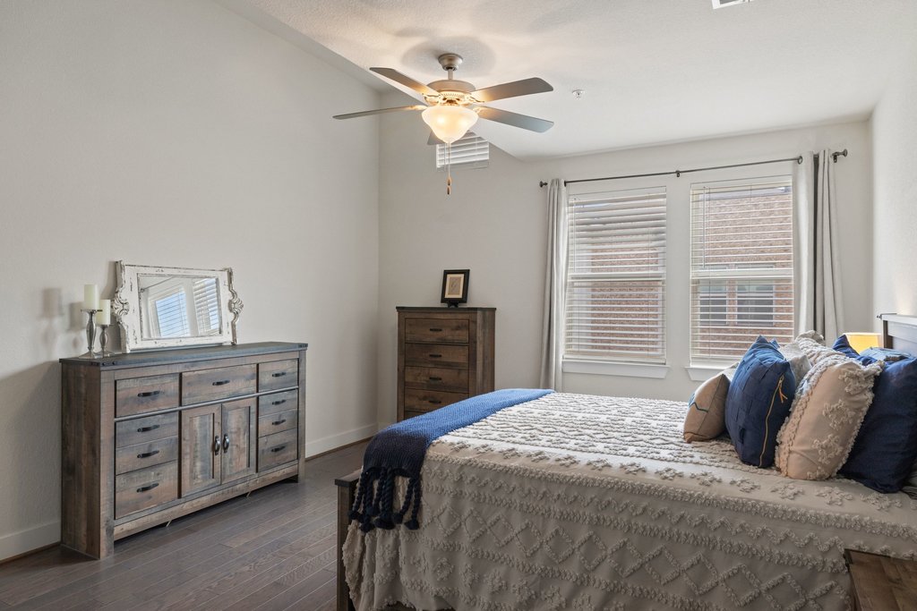 7409 Merrick Lane, Unit 40 Austin, TX 78745 - Photo 16 of 37 a bedroom that has a bed and a chandelier