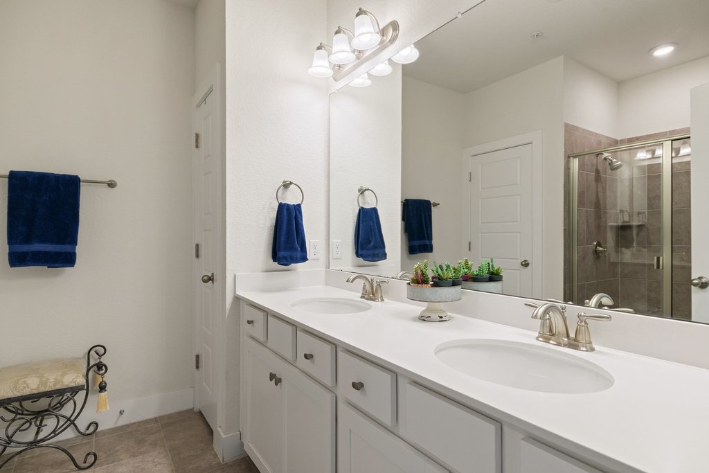 7409 Merrick Lane, Unit 40 Austin, TX 78745 - Photo 17 of 37 a bathroom with a double vanity sink and a mirror