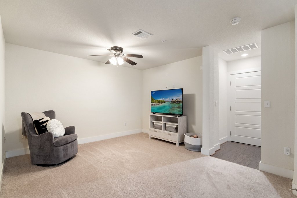 7409 Merrick Lane, Unit 40 Austin, TX 78745 - Photo 20 of 37 a living room with furniture and a flat screen tv