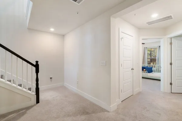 a bathroom with a granite countertop sink a toilet and a mirror