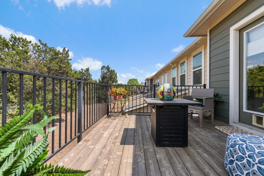 7409 Merrick Lane, Unit 40 Austin, TX 78745 - Photo 31 of 37 a living room with wooden floors a table and chairs