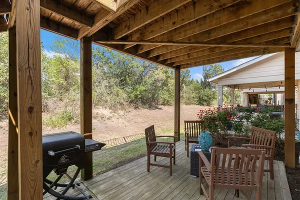 a view of a porch with furniture and wooden floor