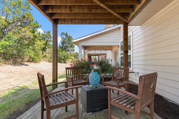 a view of a patio with a table chairs and backyard