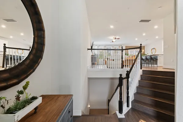 a view of entryway and hall with wooden floor