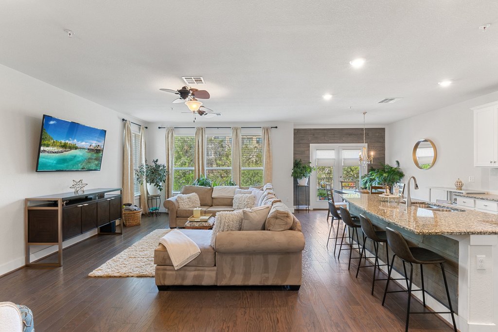 7409 Merrick Lane, Unit 40 Austin, TX 78745 - Photo 6 of 37 a living room with furniture a large window and a flat screen tv