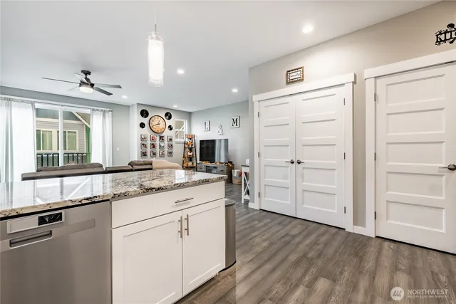 a kitchen with a sink cabinets and wooden floor