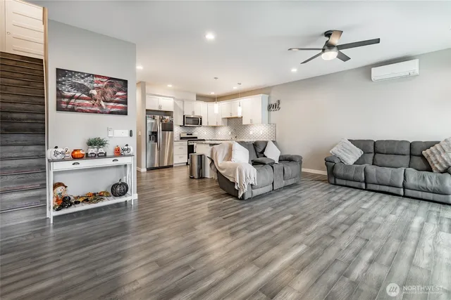 a living room with furniture and a wooden floor