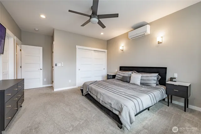 a bedroom with a bed and a chandelier