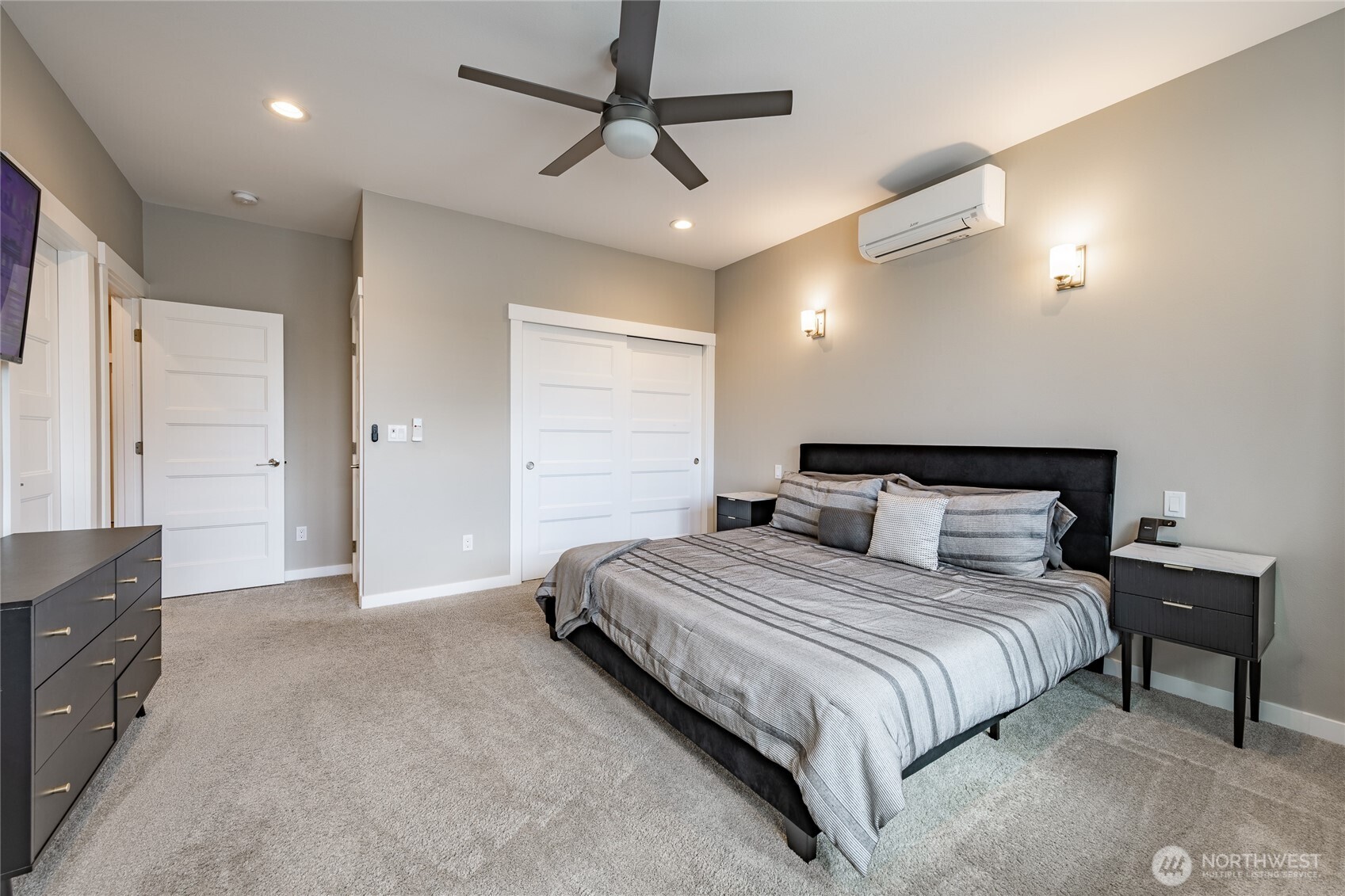 5682 Sunstone Place, Unit 103 Ferndale, WA 98248 - Photo 19 of 30 a bedroom with a bed and a chandelier