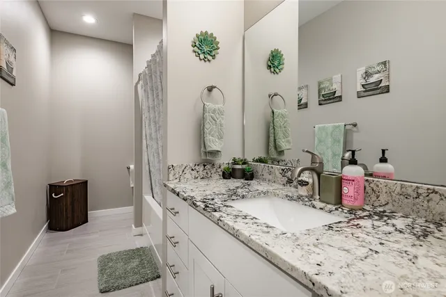 a bathroom with a shower and a sink