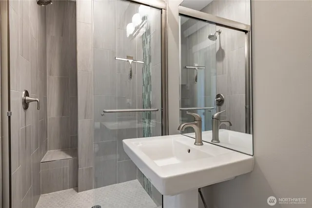 a bathroom with a sink toilet and shower