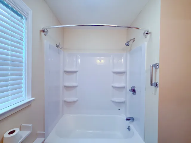 a bathroom with a shower and a tub