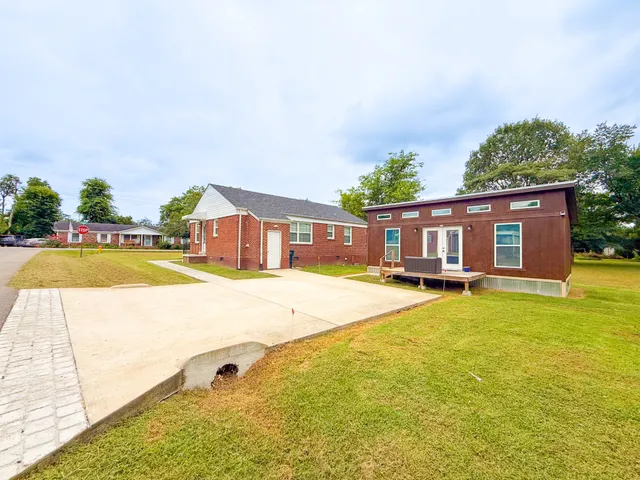 a swimming pool with outdoor seating and yard