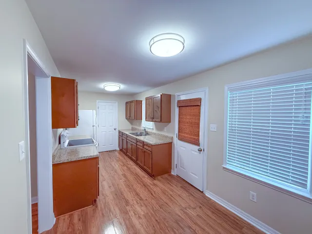 a large room with a kitchen view