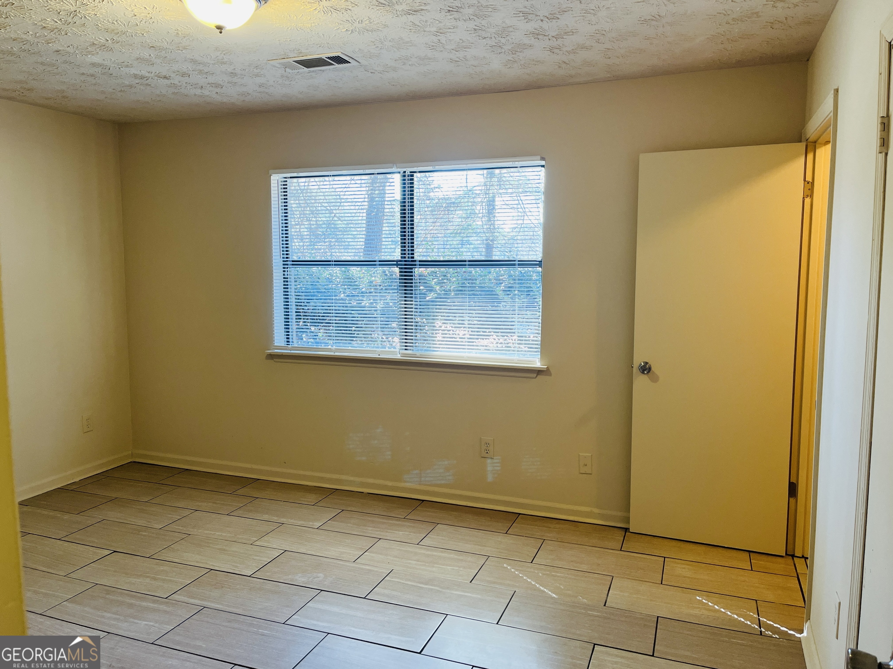 4120 Midway Road, Unit 4120 Douglasville, GA 30134 - Photo 8 of 24 a view of an empty room with a window
