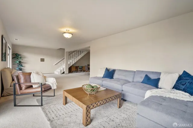 a living room with furniture and large windows