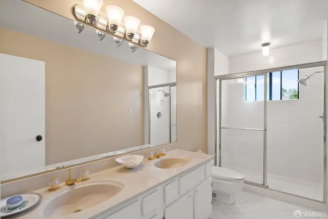 a spacious bedroom with a bed and a couch