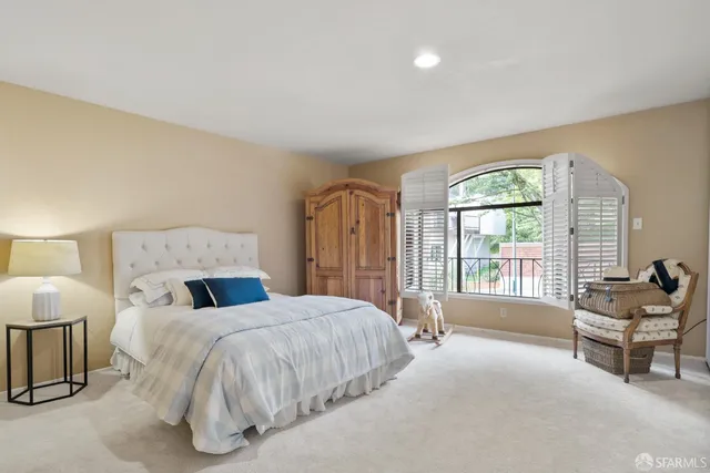 a spacious bedroom with a bed and a dresser next to a window