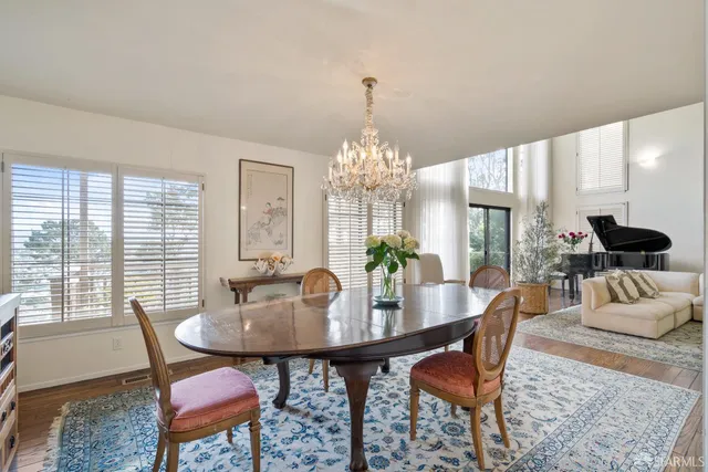 a view of a dining room with furniture and chandelier
