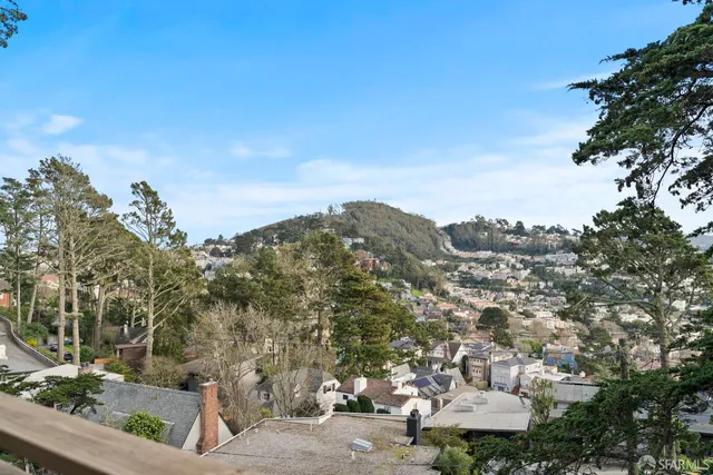 a view of a balcony with furniture and a garden