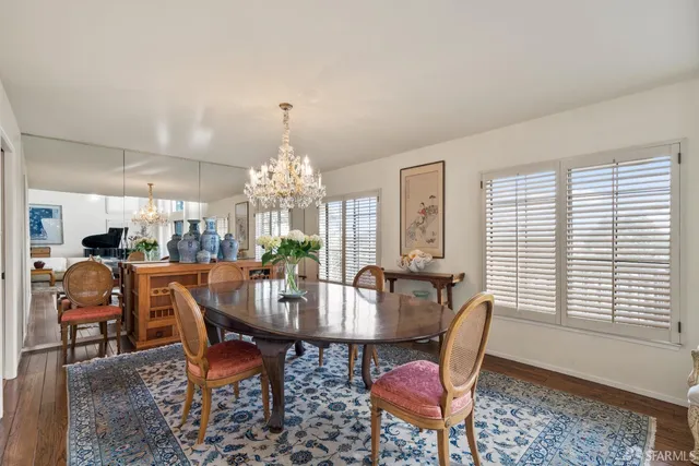 a view of a dining room with furniture and chandelier