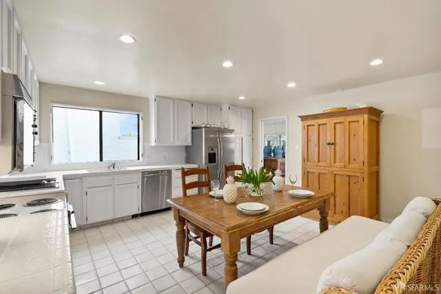 a kitchen with a refrigerator and a sink