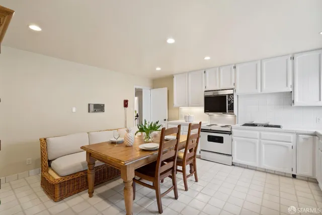 a view of kitchen with cabinets table and chairs